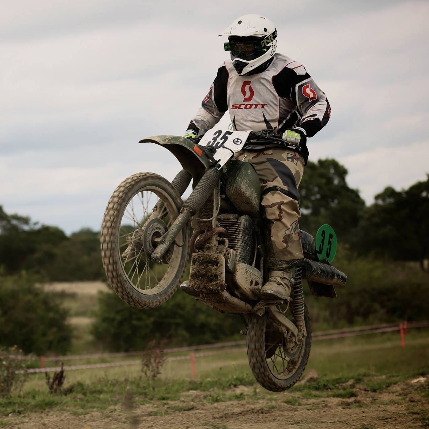 A Harley-Davidson MT350 jumping on a motocross track jump